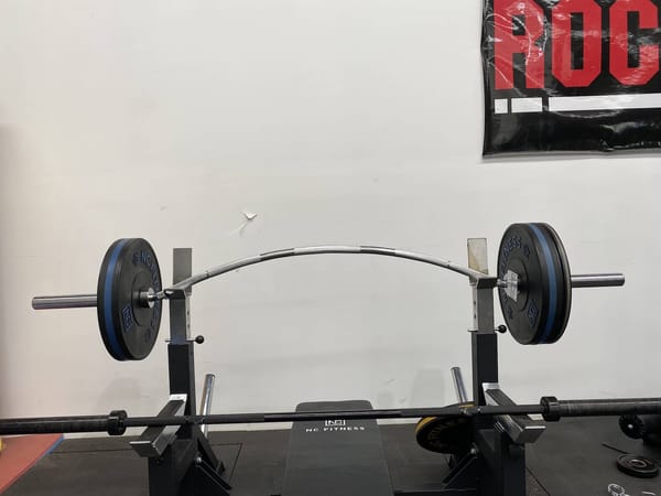 Olympic curved bow bar in use at the gym