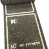 Rubber agility ladder mat shown half rolled up to demonstrate that the mat can be stored easily when not in use